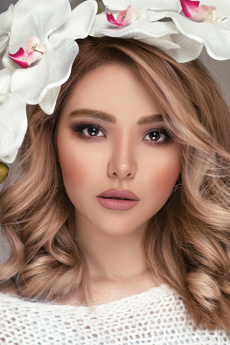 A stunning portrait of a woman adorned with a floral headpiece, highlighting beauty and elegance.